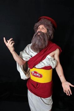 an image of a man with a long beard wearing a red and white outfit, standing in front of a black background