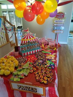 a circus themed birthday party with balloons and sweets on a table in the middle of the room