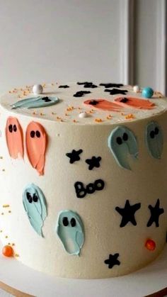 a decorated cake with ghost decorations on it