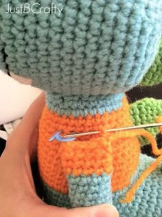 someone is holding a crocheted item in their hand and it looks like they are working on something