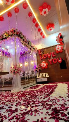 a wedding stage decorated with flowers and balloons