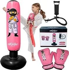 the girl is practicing her karate moves with boxing gloves and punching mitts on display