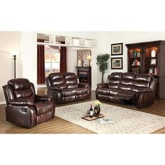 a living room filled with brown furniture and a white rug on top of a hard wood floor