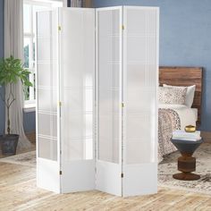 a white room divider in a bedroom