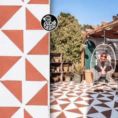 a woman sitting in a birdcage next to an image of a tiled floor