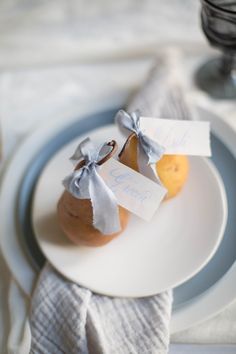 two pears on a plate with place cards