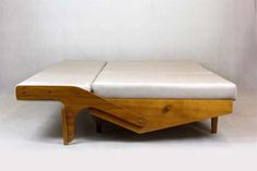 a bed that is sitting on top of a wooden frame