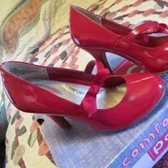 Pop Plano Red Patent Heels Mary Jane Pumps With Bow ~ Size 5 M ~ So Cute! ~ Red Patent Heels New In Box ~ Cutest Red Bow On Strap Across Top Of Each Shoe ~ Straps Have Bit Of Elastic On Side For Comfort ~ Comfort Cushion Footbed ~ @ 3-1/2" Heel Height One Shoe Has Teeny Bump That You Don't Notice, One Shoe Has Tiny Divot On Bottom That Would Not Be Seen, Box Has Very Minor Wear (See Last 3 Photos) I Welcome Any Inquiries You May Have And Will Respond Quickly. Thank You For Looking. Red Closed Toe Heels With Synthetic Material, Red Heels With Round Toe And Bow, Red Kitten Heels, Black Mary Jane Heels, Silver Block Heels, Pop Shoes, Taupe Heels, Womens Red Shoes, Shoe Palace