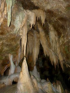 the inside of a cave with stalate formations hanging from it's ceiling