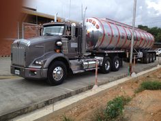 a large gray truck parked in front of a building