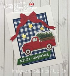 a christmas card with a red truck carrying a tree on the back and a ribbon around it