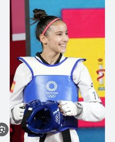 a woman holding a blue helmet in her hands