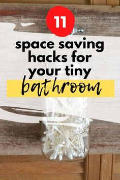 a jar filled with white cotton swabs sitting on top of a wooden counter