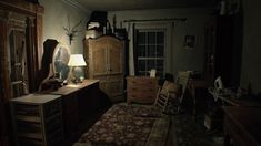 an old fashioned bedroom is dimly lit by the light from a lamp on the dresser