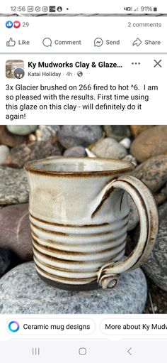 a cup sitting on top of a pile of rocks next to a rock covered ground