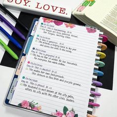 an open notebook with writing on it next to some markers and pencils that say boy love