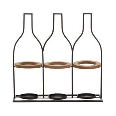 three wine bottles are sitting on a stand with two empty ones in the bottom, and one