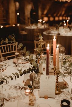 the table is set with candles and place settings