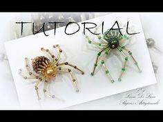 two spider brooches sitting next to each other