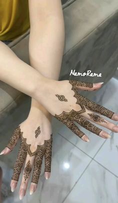 two hands with henna tattoos on them and the words nampaana written in arabic