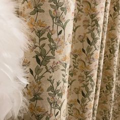 the curtains are decorated with flowers and feathers