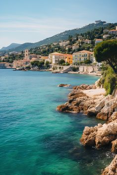 An idyllic view of a village nestled by the coastline in the charming French Riviera French Seaside, Tranquil Retreat, The French Riviera, Cote D’azur, Coastal Towns, Lush, Sun, France