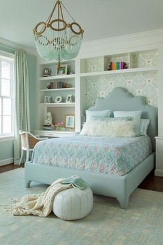 a bedroom with a bed, chandelier and bookshelves