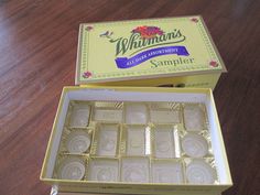 a box of white chocolates sitting on top of a wooden table