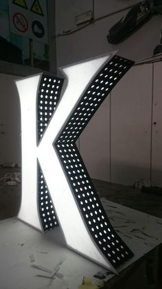 the letter k is lit up and ready to be made into a light sculpture with dots on it