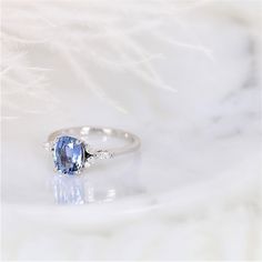 Rare to see are delicate dainty cluster rings that are both modern yet vintage. Our Geneva design is truly one of a kind with the stunning cornflower blue sapphire as the center stone with dainty marquise diamonds for the cluster! All gemstones used are only premium cut, fairly traded, and/or conflict-free! Our accent diamonds are always natural, unless specified as lab grown, and NEVER treated for better color or clarity. For peace of mind, everything within our Rosados Box® line is NEVER simul Delicate Blue Anniversary Rings, Elegant Light Blue Sapphire Ring With Accent Stones, Elegant Sapphire Cluster Ring With Birthstone, Elegant Light Blue Sapphire Ring With Center Stone, Elegant Light Blue Sapphire Ring, Lavender Sapphire, Cornflower Blue Sapphire, Cluster Rings, Cushion Ring