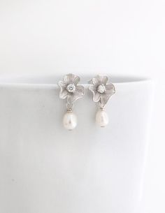 These beautiful earrings are perfect for brides or bridesmaids. They are made with small Freshwater Pearls that were carefully attached to Gold over Sterling Silver Posts with a Gold Plated Flower and a tiny Cubic Zirconia. Simply classy and beautiful to combine with any outfit. Total size of these gorgeous pearl earrings is about 1 inch or 25mm.Quantity discounts available for your bridal party.:::::::::::::::::::::::::::::::PACKAGING:I will send your gorgeous jewelry carefully packed and ready Mother Of The Groom Jewelry, Mother Of The Bride Jewelry, Bridal Drop Earrings, Small Pearl Earrings, Earrings For Bride, Bridesmaid Pearl Earrings, Gold Earrings Wedding, Bridesmaid Pearls, Pearl Bridal Jewelry