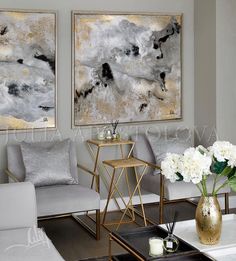 a living room with two paintings on the wall