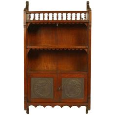 an antique wooden bookcase with decorative carvings