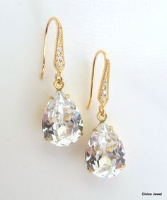 "These romantic earrings have clear Austrian teardrop crystals. . Hooks ear wires are nickel free gold plated over 92.5 sterling silver over brass. They have small cubic zirconia set in. Earrings are approximately 1 1/4\" long from top to bottom. Crystal measures 1/2\" by 3/8\" at its widest point or 14 x 10 mm. They make a great gift for someone special, bridesmaid, maid of honor, mother of the bride, mother of the groom, or just simply to spoil yourself!" White Sparkling Teardrop Earrings, Pearl Drop Teardrop Crystal Earrings, Classic Teardrop Crystal Earrings For Parties, Classic Crystal Teardrop Earrings For Party, Crystal Teardrop Earrings With Pearl Drop, Classic Sparkling Teardrop Crystal Earrings, Classic Crystal Teardrop Earrings, White Crystal Teardrop Earrings, Classic Crystal Teardrop Bridal Earrings