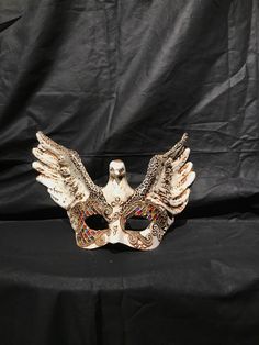 Eagle Mask. Traditional and original papier-mache Venetian mask, handmade and decorated with acrylics colors,stuggles,glitter and wax. The mask has double paper mache. All our masks are handmade papier-machè masks made in Venice. Our decorators use techniques typical of the Venetian tradition such as stucco, acrylics, gold and silver-leaf, macramè, passementerie, pearls and crequelè to give you a wide range of masks This shape is available in many different designs, colors and techniques. Ask us Traditional White Mask For Carnival, Traditional Mardi Gras Masquerade Mask, Traditional Masquerade Mask For Carnival, Traditional White Masks For Carnival, Traditional White Carnival Mask, Traditional Eye Mask For Masquerade, Traditional White Masquerade Mask For Carnival, Venetian Multicolor Masquerade Mask, Artistic Multicolor Masquerade Mask For Carnival