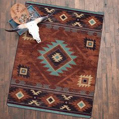 an area rug with a cow skull on top of it and other items laying next to it