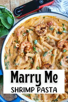 a bowl filled with shrimp pasta on top of a wooden table