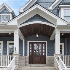 the front entrance to a house with two large doors