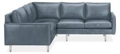 a blue leather sectional sofa with footstool and arm rest in front of it