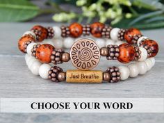 About the Bracelet Inspiring yet earthy bracelet with your choice of word. A great reminder to Just Breathe... Word Choices: Just Breathe, Strength, Journey, Love, Patience, Breathe, Namaste, Sister, Imagine, Love Life, Believe, Faith Bracelet Details: This rustic red message bracelet is made with: ♥ 8mm Rustic Red Salwag Seeds♥ 6mm Riverstone ♥ A natural wood bead engraved with "Just Breathe" ♥ Sun focal bead All items are handmade and shipped within 1-3 business days. FREE U.S. SHIPPING ON ORD Fall Jewelry Trends 2023, Breathe Bracelet, Popular Bracelets, Faith Bracelet, Word Choice, Message Bracelet, Chic Bracelet, Yoga Bracelet, Just Breathe