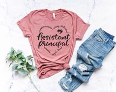 a t - shirt that says assistant principals on it next to ripped jeans and a plant