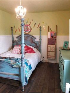 a bed room with a neatly made bed and dresser