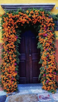 an orange flowered arch over a wooden door