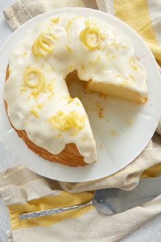 a white plate topped with a cake covered in frosting