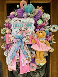 a door hanger decorated with lots of colorful stuff animals and items that say sweet shop