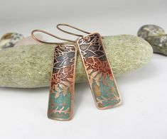 I produce designs by hand or digitally and transfer these onto metal using modern etching techniques.The metal has been patinated and partly polished to enhance the natural texture. Unique copper earrings with colorful Wax Patina. Each piece is sealed with a lacquer.  Total length including ear wires is approx 2.1  x  0.5inches or     5.4 x 1.2 cm.  All jewelry is handcrafted in my home studio. Item ships free registered mail. All my items are safely and nicely packed in solid gift boxes, ready for gift giving! Enter my shop here: https://www.etsy.com/shop/DrahomiraJewelry Patterned earrings: https://www.etsy.com/shop/DrahomiraJewelry?ref=seller-platform-mcnav&section_id=22354425 Patterned pendant: https://www.etsy.com/shop/DrahomiraJewelry?ref=seller-platform-mcnav&section_id=22342628 Ham Etched Copper Jewelry, Etching Techniques, Jewelry Journal, Copper Earrings Handmade, Copper Anniversary Gifts, Copper Anniversary, Etched Copper, Copper Jewelry Handmade, Bohemian Earrings