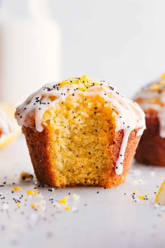 a close up of a muffin with icing and sprinkles on it