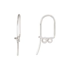 a pair of silver ear clips on a white background with clippings in the shape of an eye