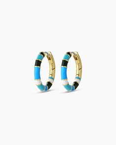 The Gigi Enamel Stripe Hoop earrings instantly elevate an outfit. Their lightweight, statement-making style features an enamel design accented by a stunning gold-plated finish. Easily style them with other gold or diamond studs and huggies to complete your look! Profile diameter measures 3/4" Hand painted enamel Surgical steel post with hinge closure Available in 18k gold plated brass Avoid contact with anything containing derivatives of alcohol Trendy Gold Enamel Hoop Earrings, Trendy Enamel Hoop Jewelry, Trendy Round Enamel Hoop Earrings, Hoop Huggie Earrings In Enamel, Modern Enamel Hoop Earrings, Steel Post, Diamond Studs, 18k Gold, Gold Plate