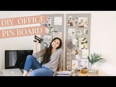 a woman sitting on top of a desk holding up a sign that says diy office pin board